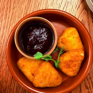 Breaded brie wedges and cranberry dip
